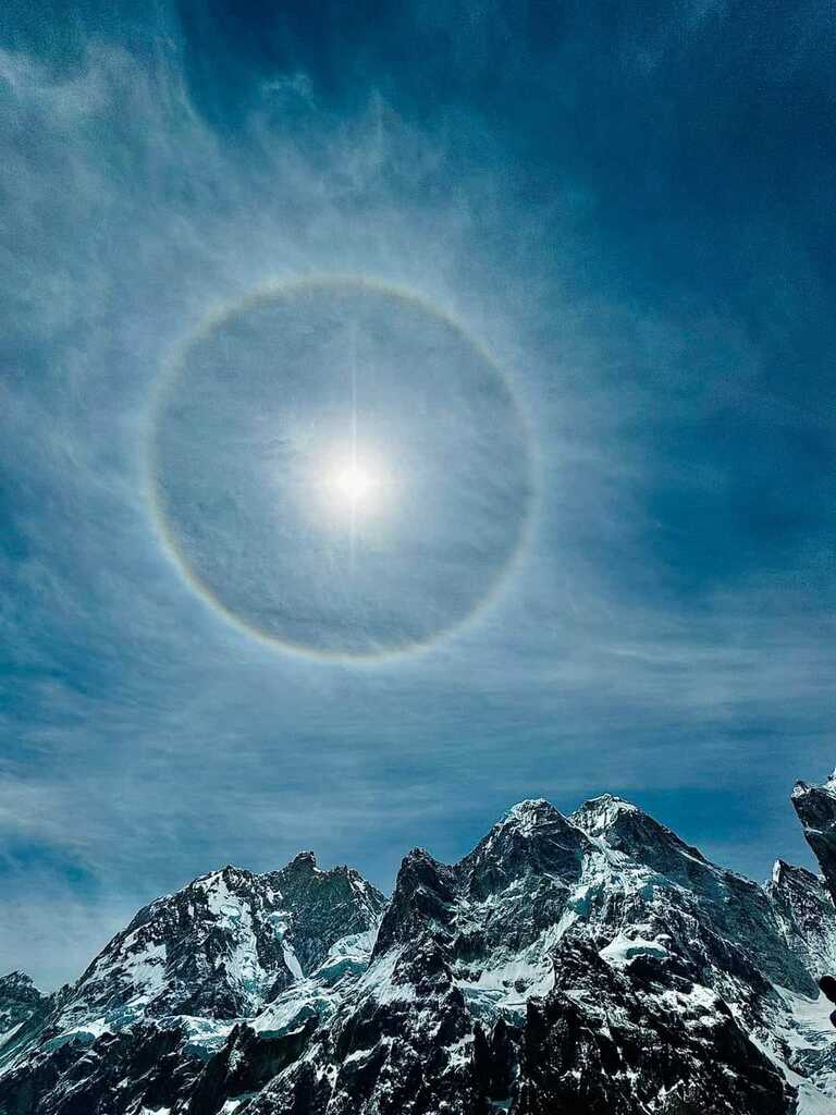 The view of Annapurna at Mid day with big circle of sunlight at background and snow is shining.